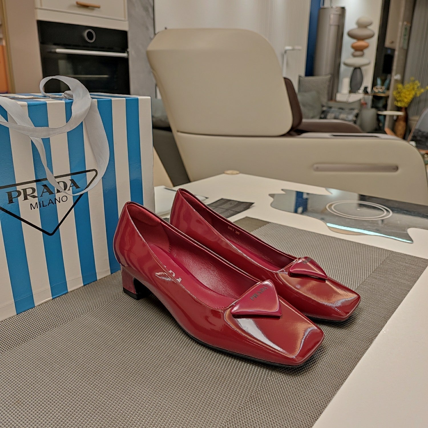 PRADA TRIANGLE LOGO PUMPS IN CURRANT RED GLOSSY CALFSKIN