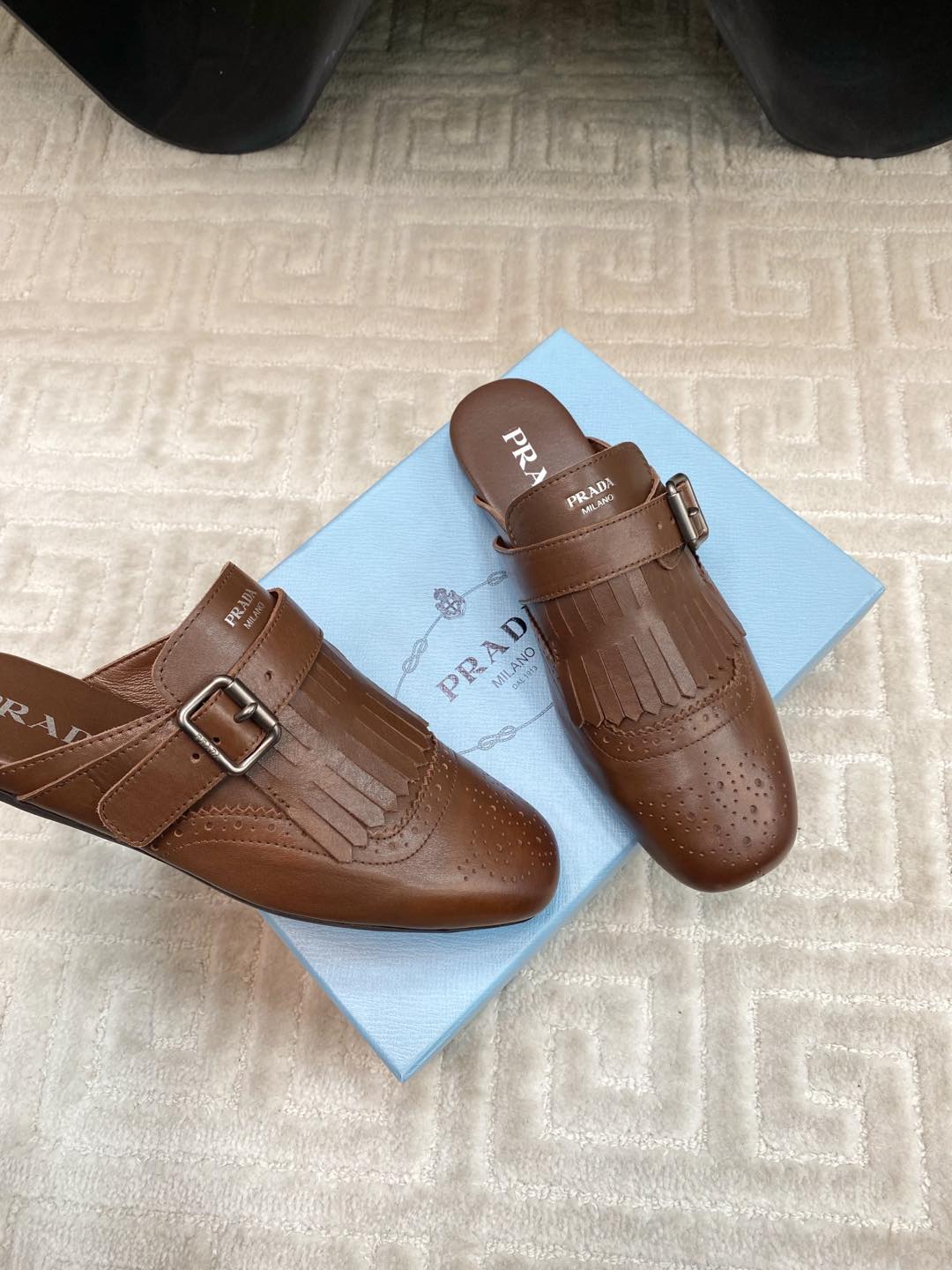 PRADA TASSEL MULES IN RUSSET BROWN LAMBSKIN