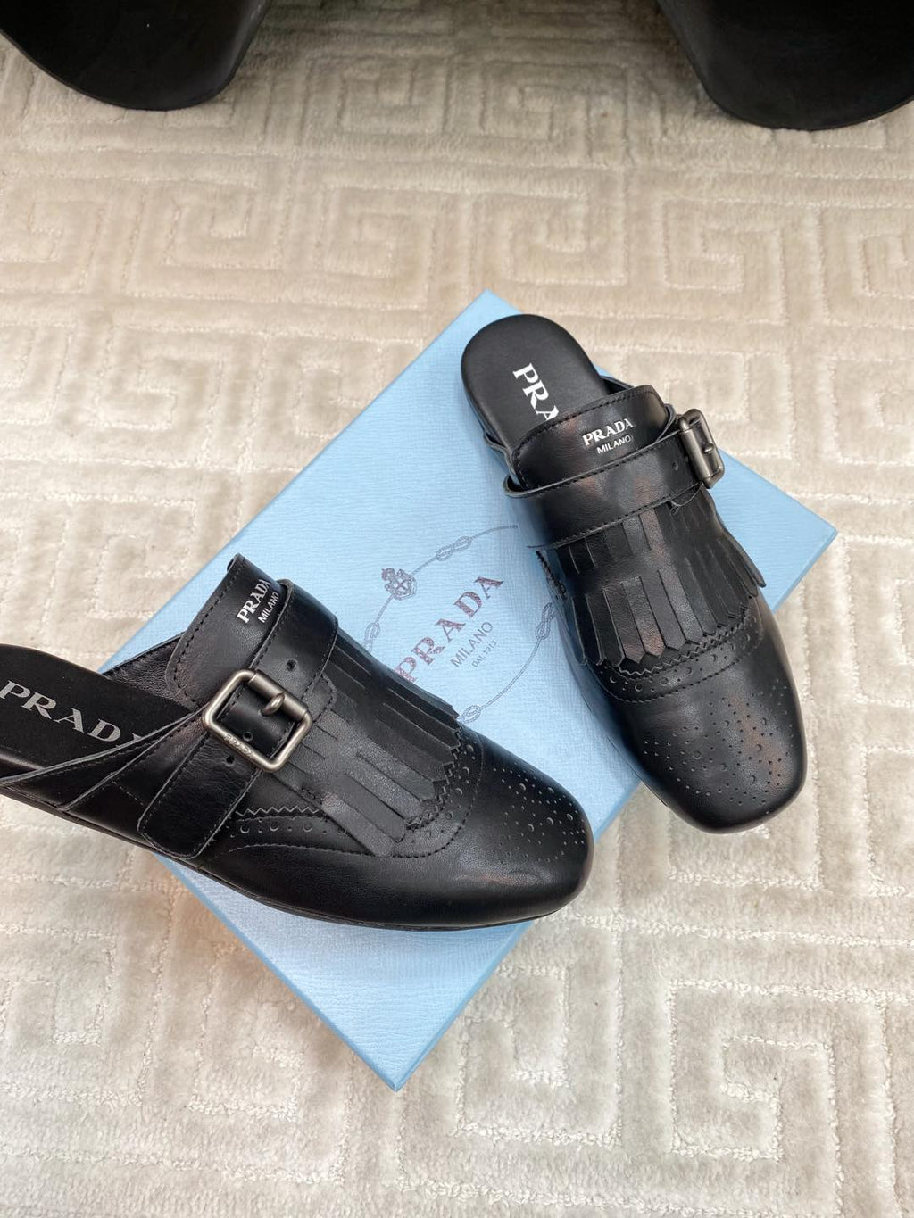 PRADA TASSEL MULES IN BLACK LAMBSKIN
